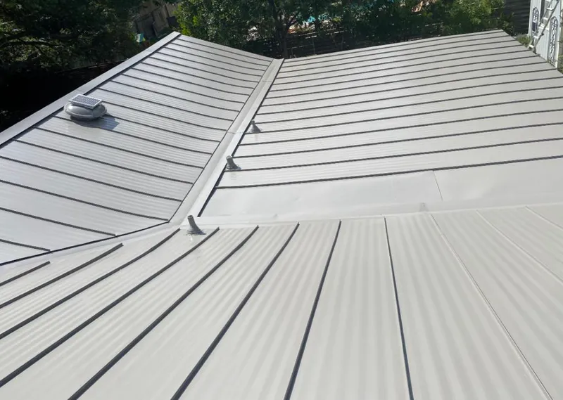 Solar attic fan installed on a metal roof for Roof Ventilation in Schuyler Falls
